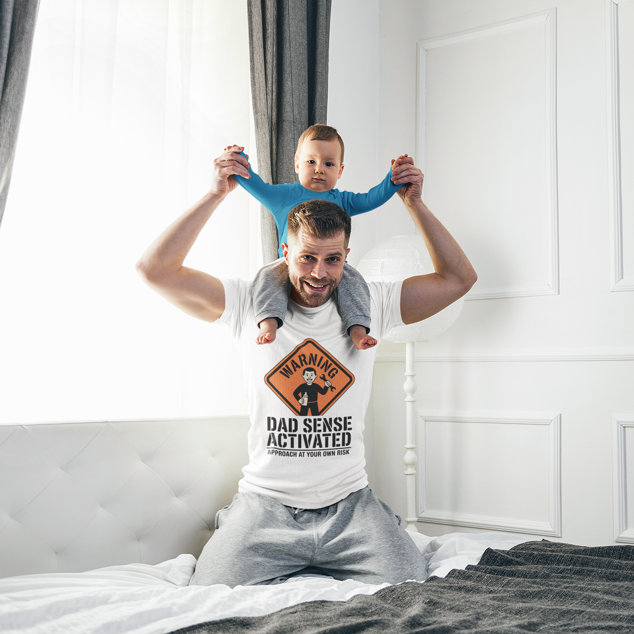 Man doing a playful dad pose while wearing a white TEEZOCA “Warning Dad Sense Activated” graphic t-shirt.