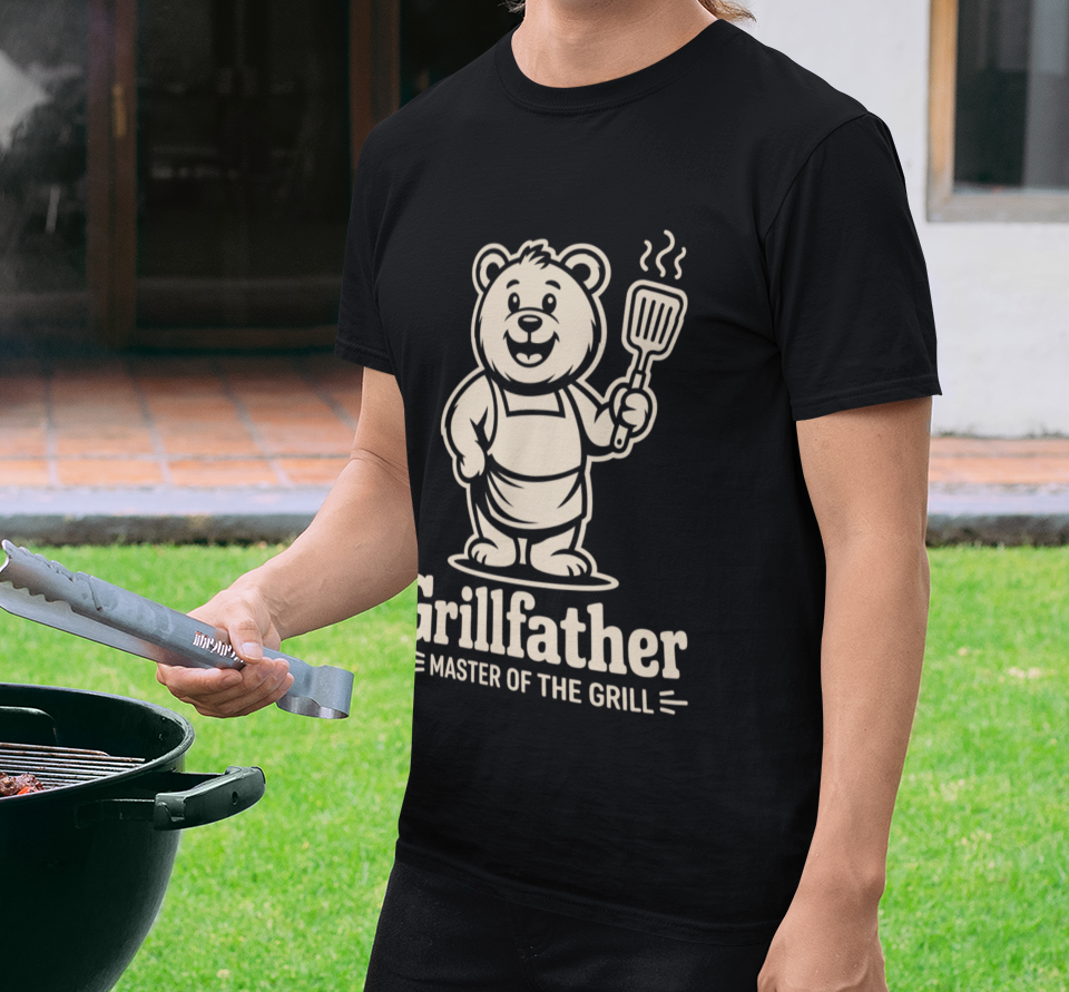 Dad grilling outdoors in a TEEZOCA “Grillfather Master Of The Grill” funny BBQ T‑shirt.
