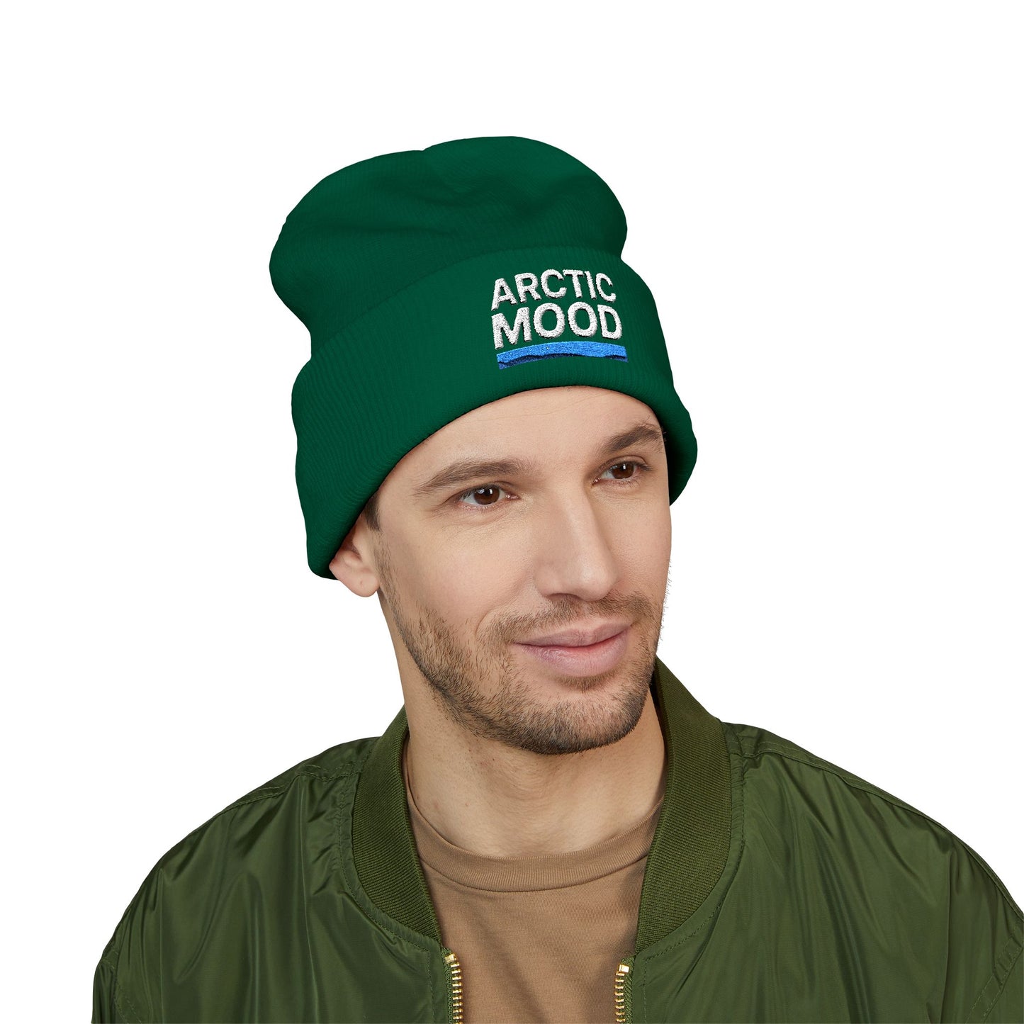 Man wearing a green 'Arctic Mood' beanie on a white background