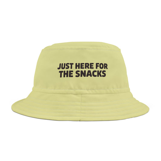 Funny sarcastic light green bucket hat with text 'JUST HERE FOR THE SNACKS' on a white background. TEEZOCA