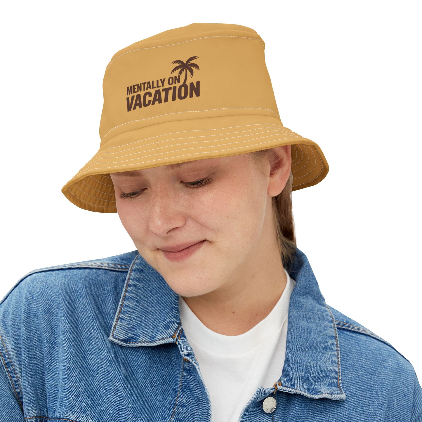 Funny yellow bucket hat with 'Mentally on Vacation' text and palm tree design on a white background. TEEZOCA