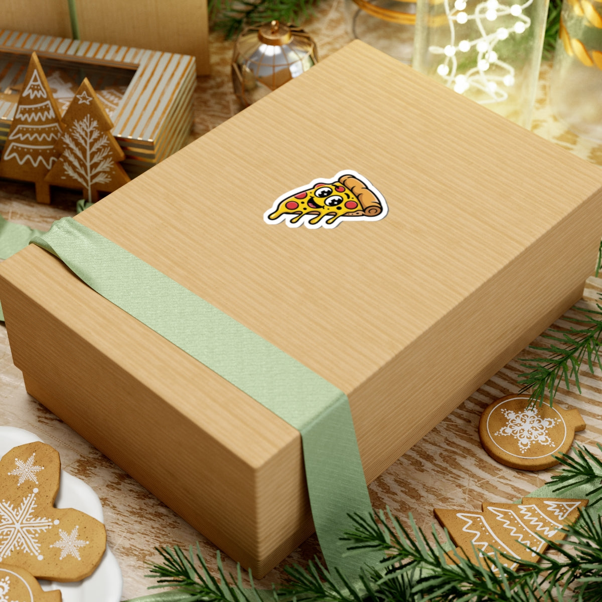 Gift box with a pizza sticker on a wooden surface with Christmas decorations. TEEZOCA