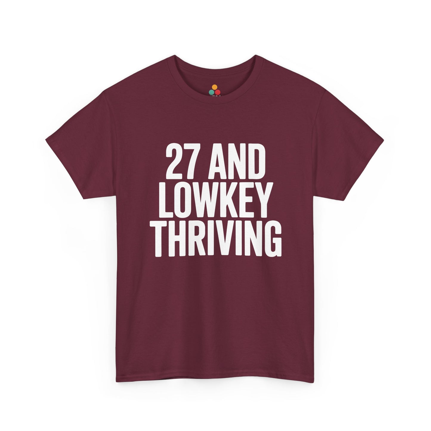Maroon t-shirt with white text '27 AND LOWKEY THRIVING' on a white background