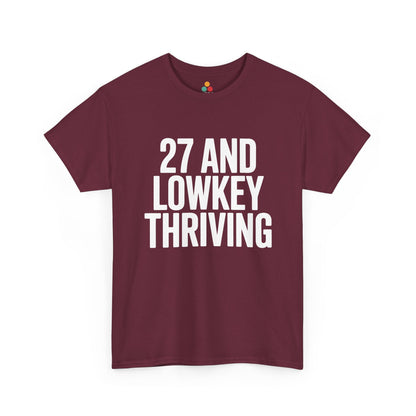 Maroon t-shirt with white text '27 AND LOWKEY THRIVING' on a white background
