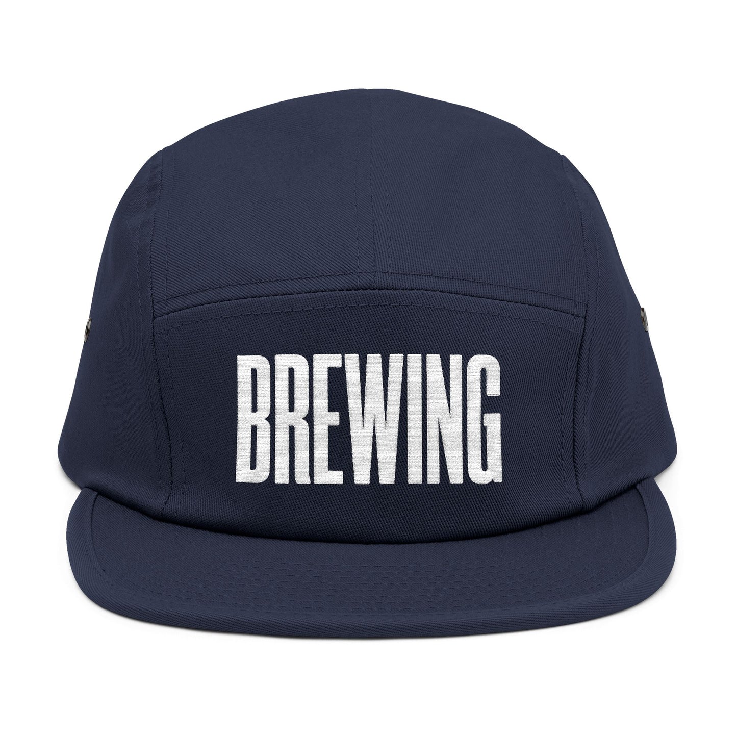 Navy blue cap with 'BREWING' text on a white background. BREWING minimalist text embroidery design on 5-panel cap. TEEZOCA