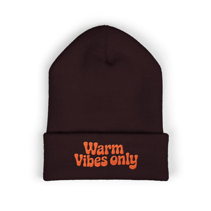 Brown beanie with 'Warm Vibes only' text in orange on a white background. Winter beanie with bold orange embroidered text adding warm, positive energy.