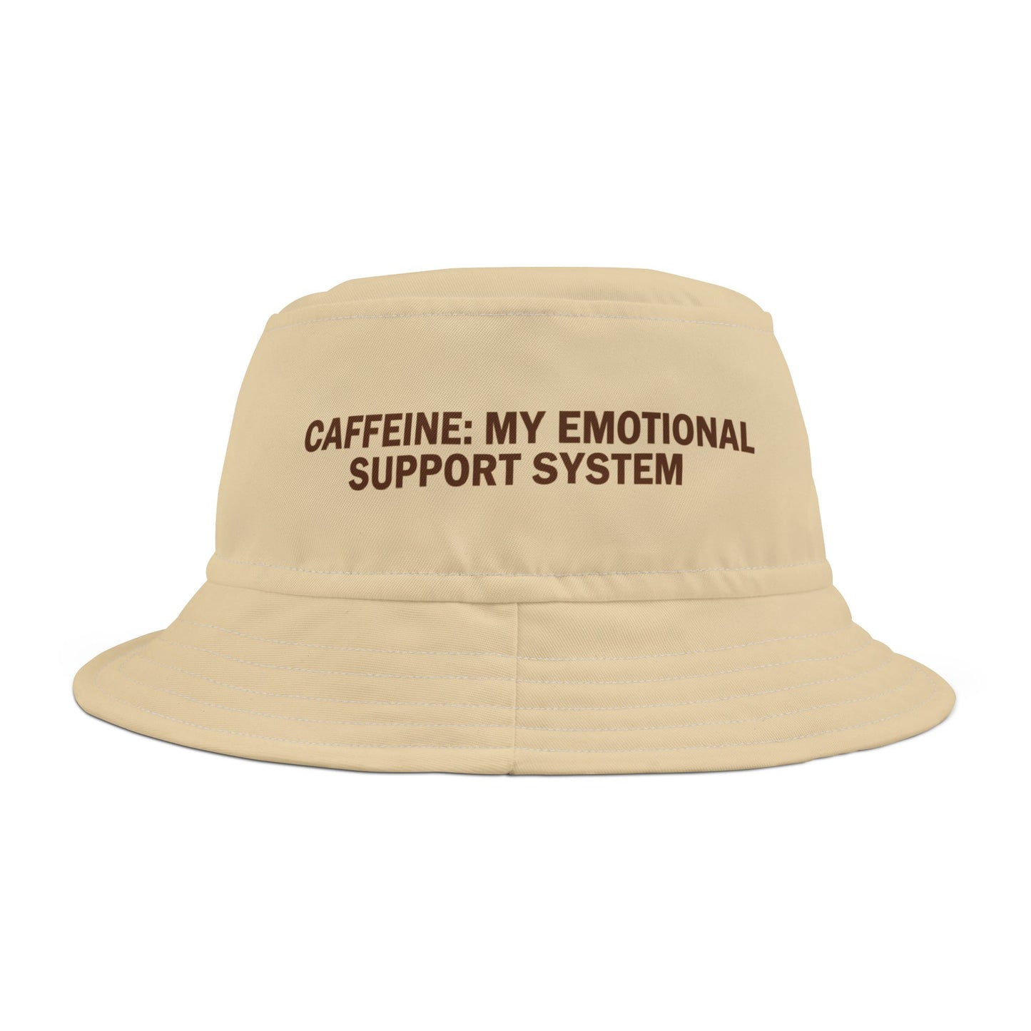 Beige bucket hat with funny text 'CAFFEINE: MY EMOTIONAL SUPPORT SYSTEM' on a white background. TEEZOCA