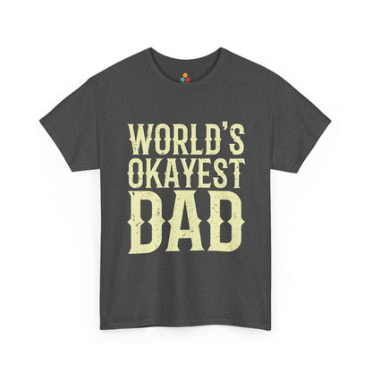  Charcoal grey “WORLD’S OKAYEST DAD” T‑shirt in bold vintage cream text, flat front mockup.