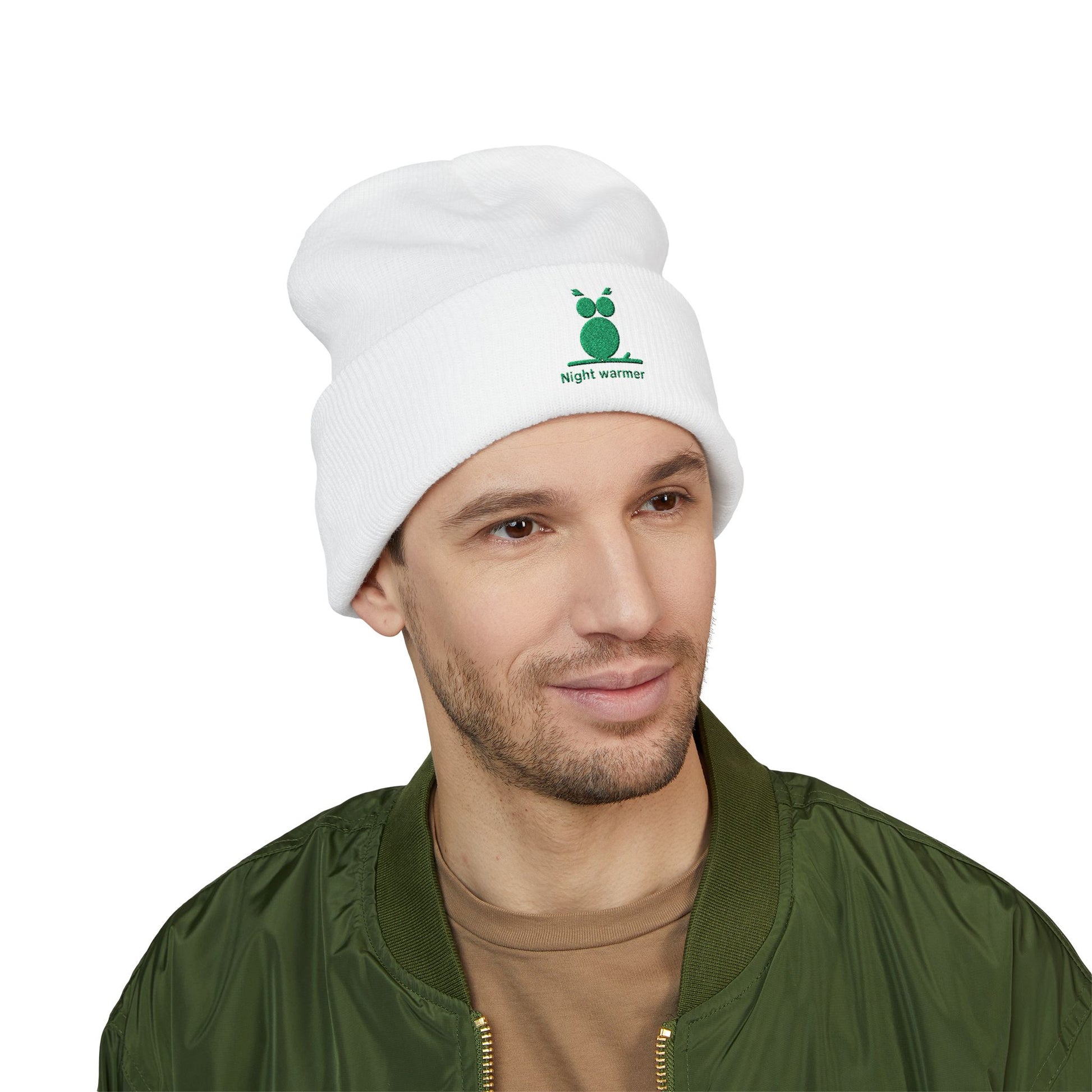Man wearing a white beanie with a logo and text, on a white background. Green embroidered emblem on soft cuffed winter beanie
