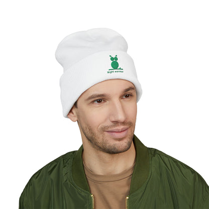 Man wearing a white beanie with a logo and text, on a white background. Green embroidered emblem on soft cuffed winter beanie