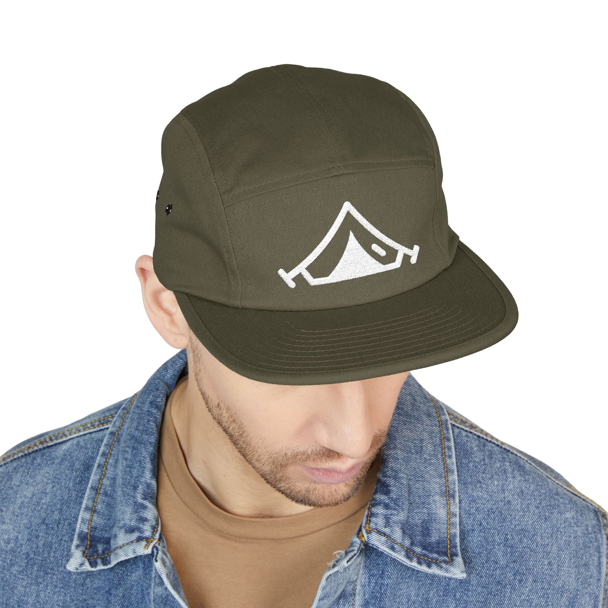 Green cap with a logo worn by a person on a white background. Outdoor adventure tent symbol for embroidery designs. TEEZOCA