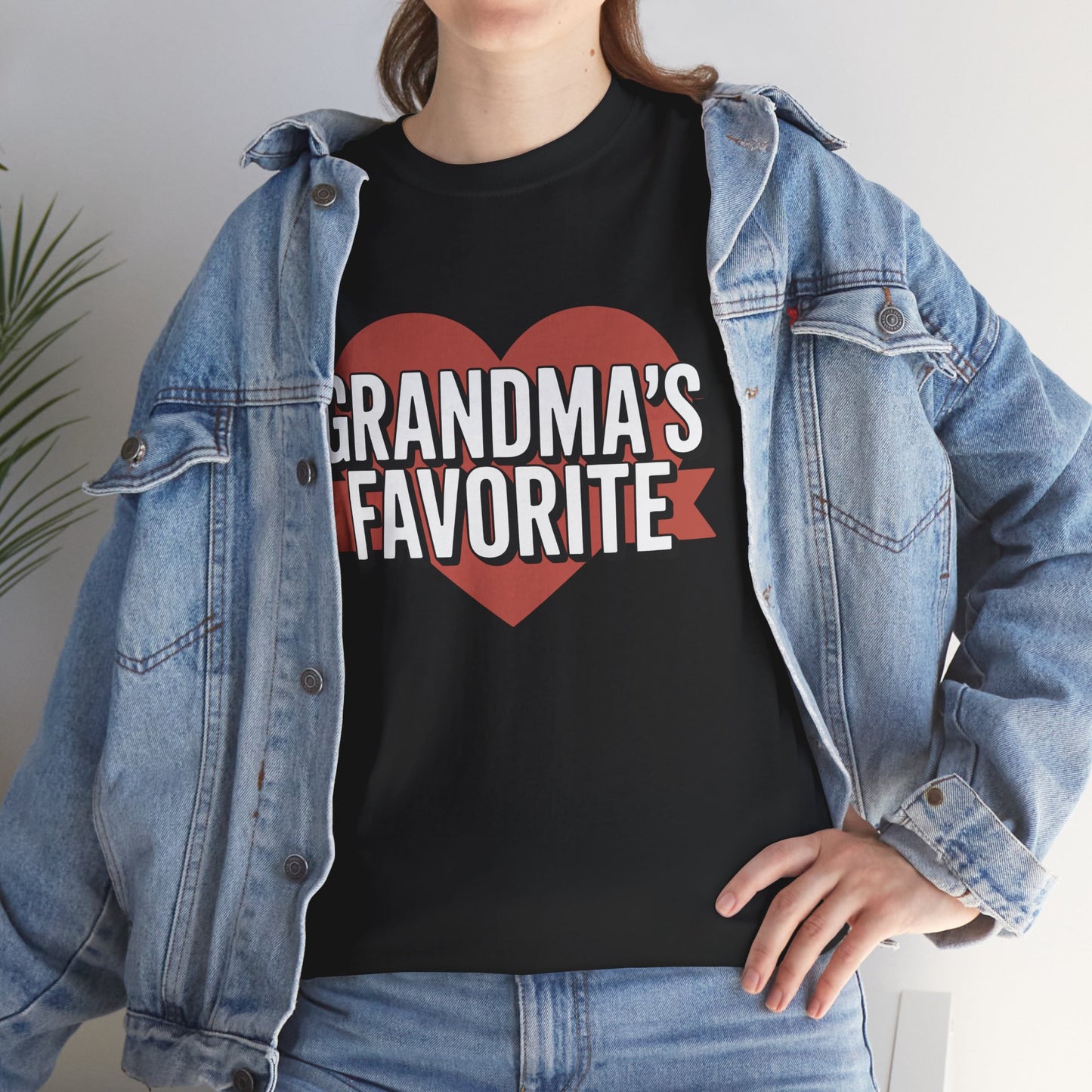 Woman in a denim jacket layering a TEEZOCA “Grandma’s Favorite” grandkid shirt.