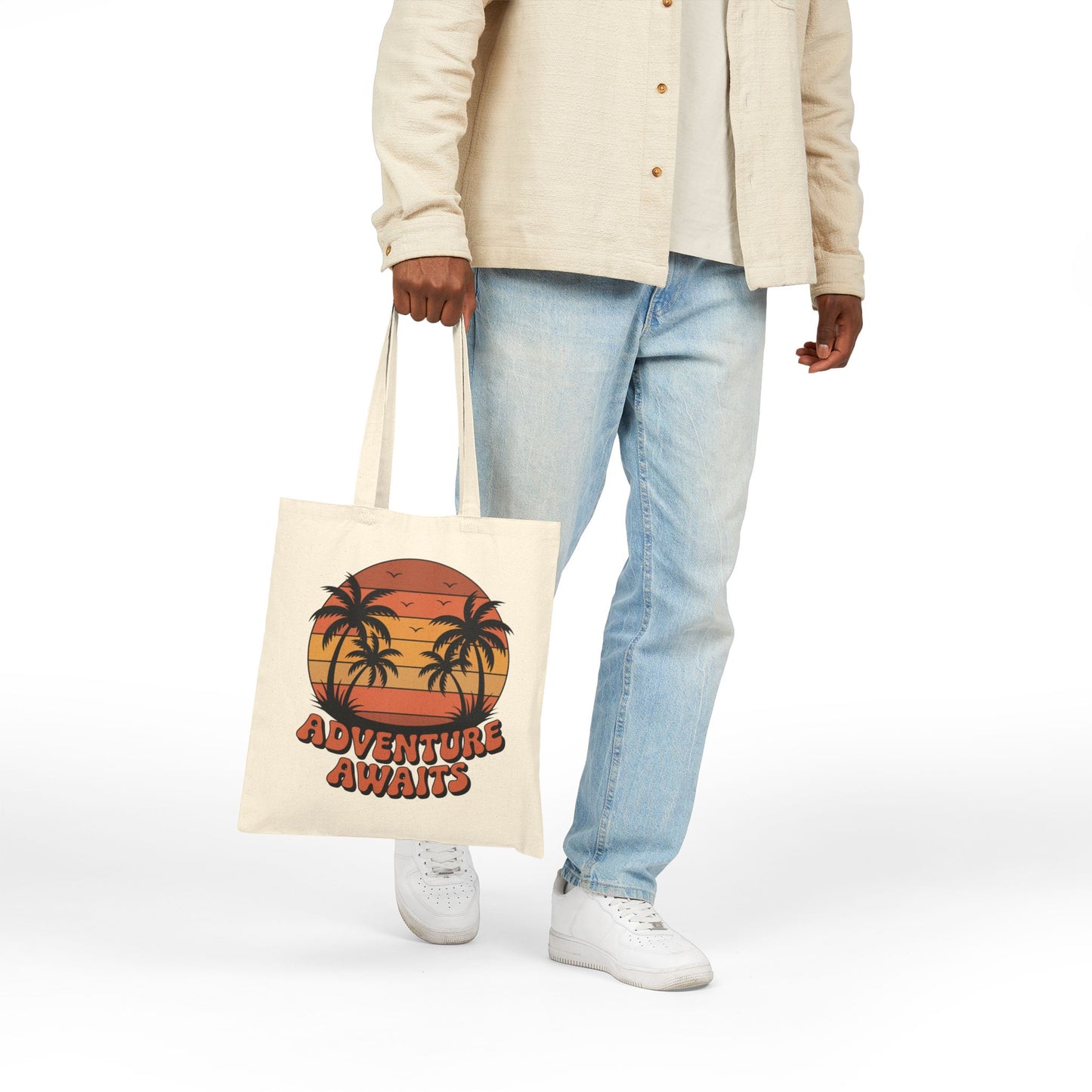 Retro sunset and palm trees Adventure Awaits artwork on a TEEZOCA tote bag