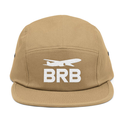 Tan cap with 'BRB' and airplane logo on a white background. Minimalist BRB airplane embroidered design for 5-panel cap by TEEZOCA