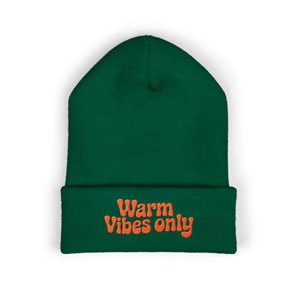 Green beanie with 'Warm Vibes only' text on a white background. Soft cuffed beanie featuring optimistic “Warm vibes only” embroidery.