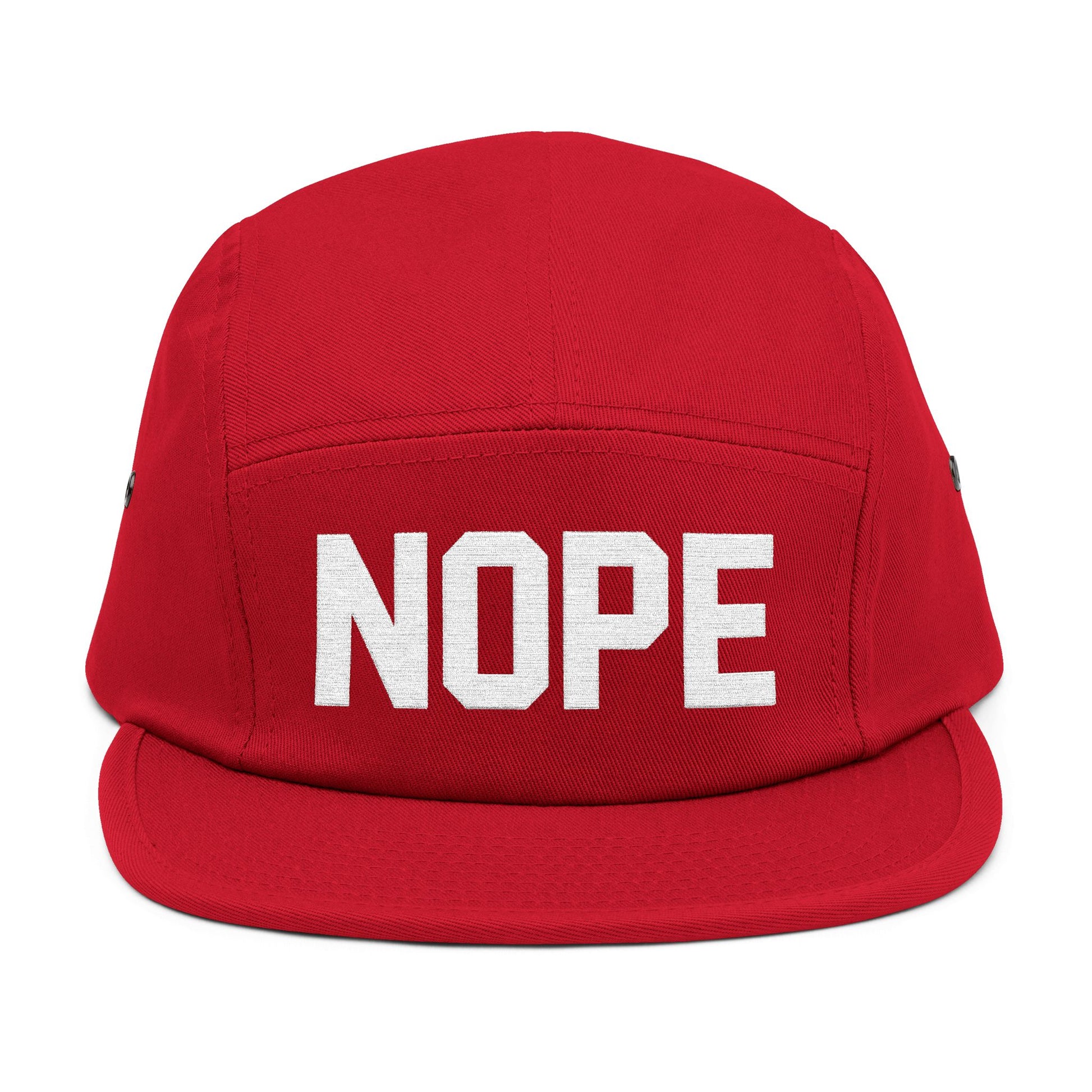 Red cap with 'NOPE' text on a white background. NOPE bold minimal typography embroidery design on cap. TEEZOCA