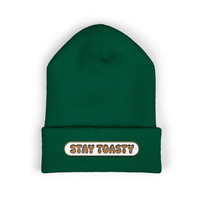 Green beanie with 'Stay Toasty' text on a white background