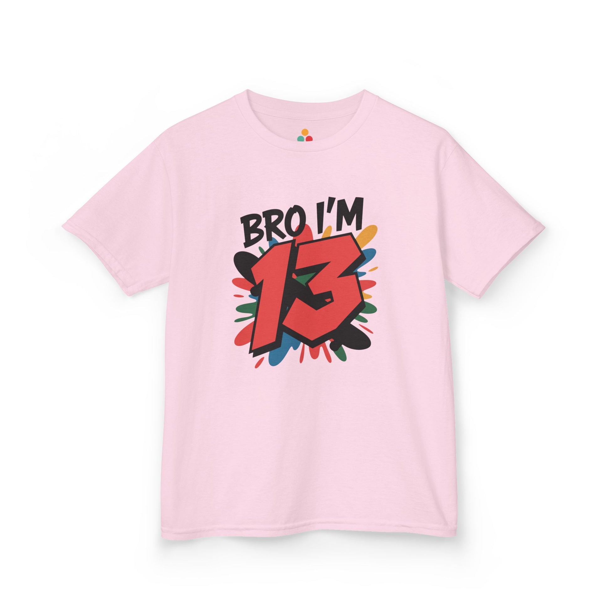 Light pink kids’ t‑shirt with “Bro I’m 13” graffiti text, big red 13, and multicolor paint splash, flat front view.