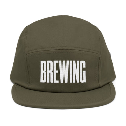 Green cap with 'BREWING' text on a white background. BREWING minimalist text embroidery design on 5-panel cap. TEEZOCA