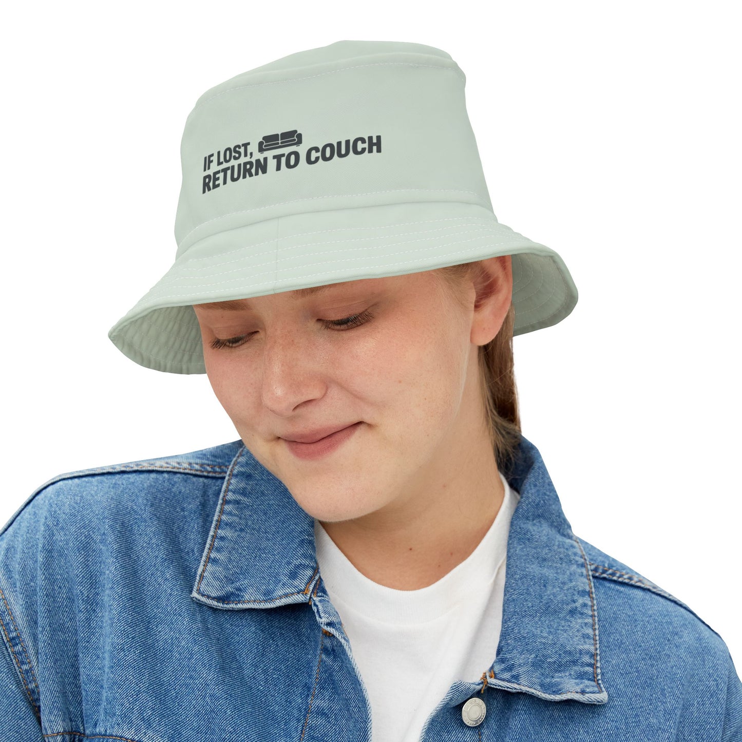 Funny sarcastic light blue bucket hat with text 'IF LOST, RETURN TO COUCH' on a white background. TEEZOCA
