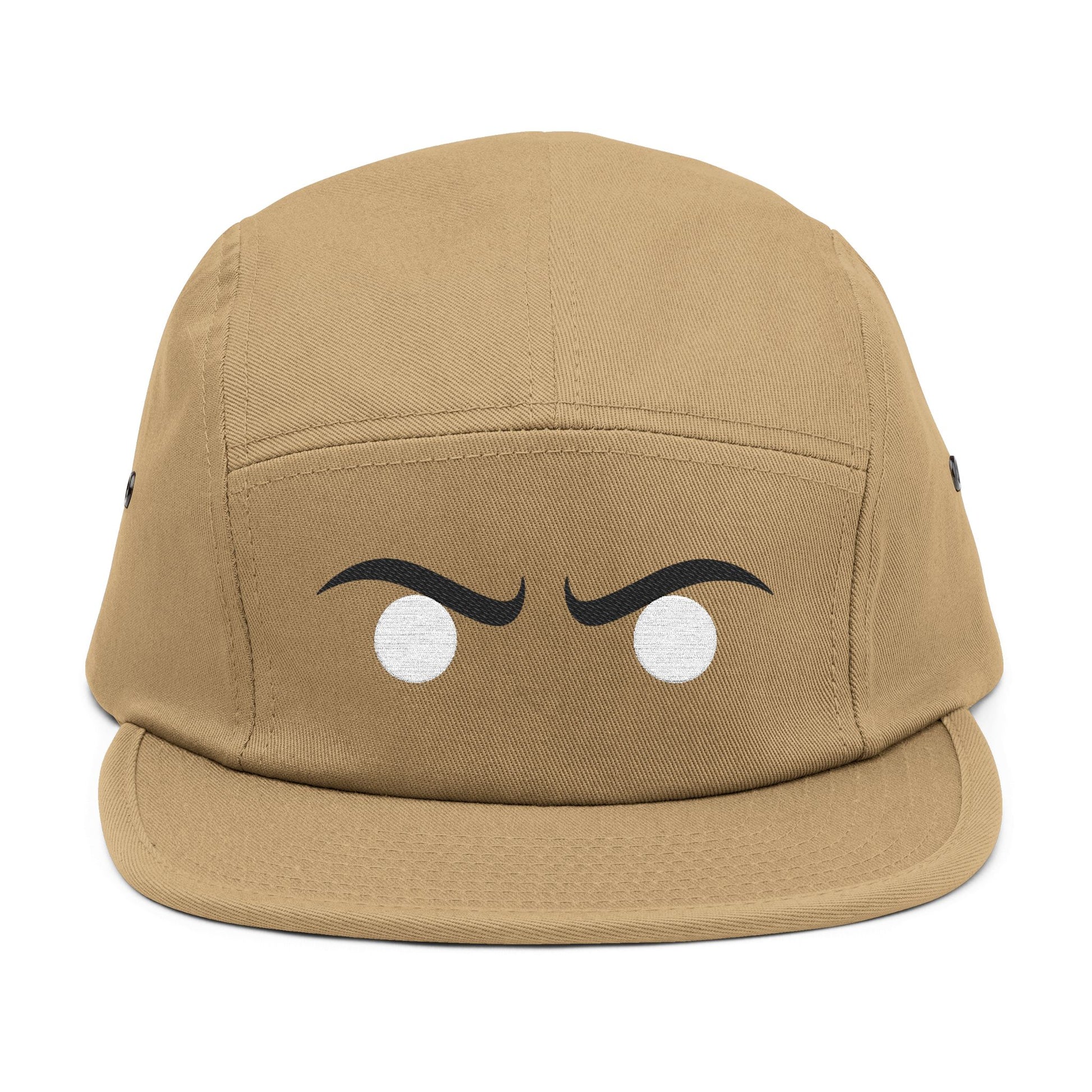Tan cap with cartoonish eyes on a white background. Stylized angry expression graphic optimized for embroidery. TEEZOCA