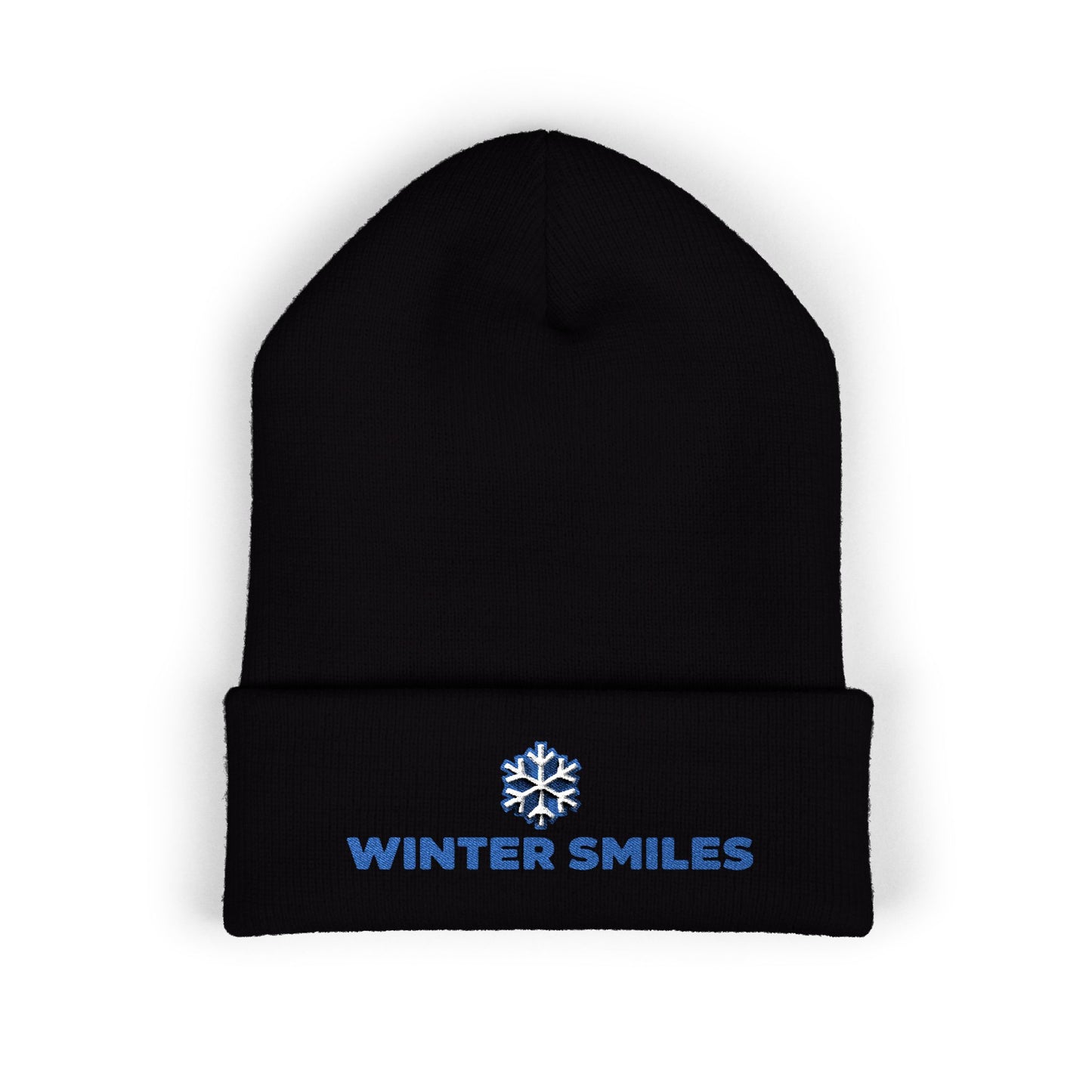Black beanie with 'Winter Smiles' text and snowflake logo on a white background. Blue embroidered “Winter Smiles” snowflake design on cuffed winter beanie