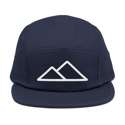 Navy blue cap with white mountain logo on a white background. Minimal mountain outline design embroidered on a 5-panel cap. TEEZOCA