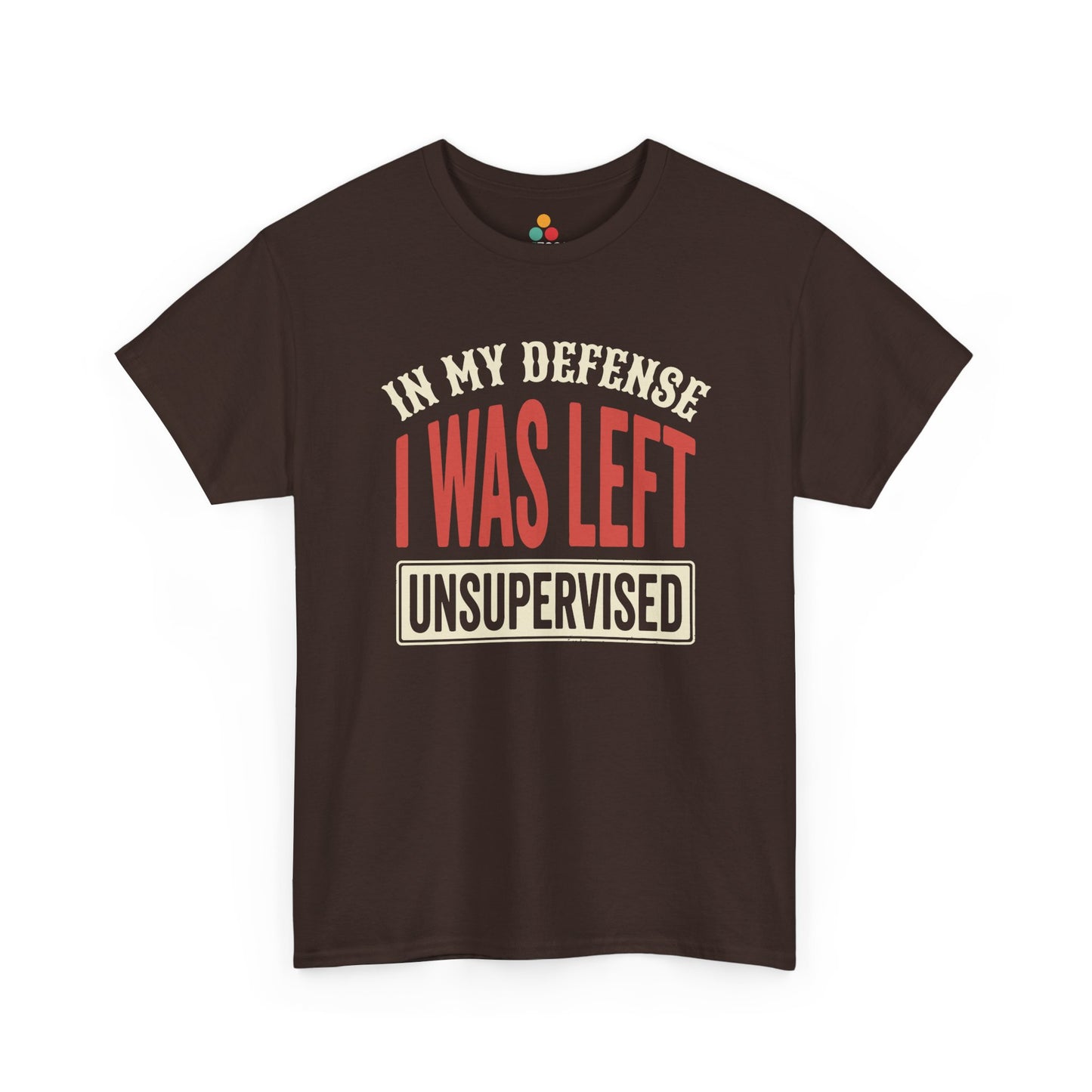 a Brown T-shirt featuring the phrase “In My Defense I Was Left Unsupervised” in bold red and cream retro-style text, funny sarcastic quote shirt, witty statement tee, dry humor graphic tee, adult humor apparel, retro typography shirt, bold statement shirt, playful sarcasm tee, humorous quote t-shirt, chaos humor shirt, and funny novelty graphic tee.

