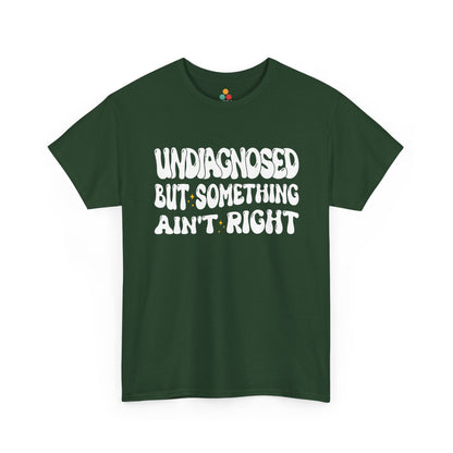 “Teezoca Undiagnosed But Something Ain’t Right shirt, funny neurodivergent quote in wavy letters, forest green tee, front.”​

