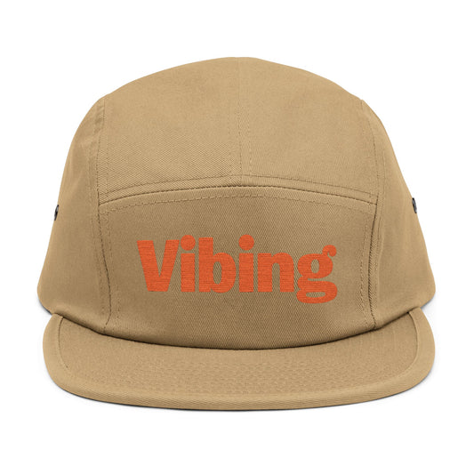 Beige cap with 'Vibing' text on a white background. Vibing embroidered text design on minimalist 5-panel cap. TEEZOCA