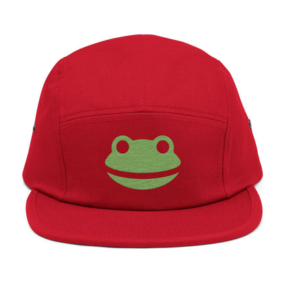 Red cap with a green frog logo on a white background. Minimalist frog face embroidery design with wide smile and round eyes. TEEZOCA