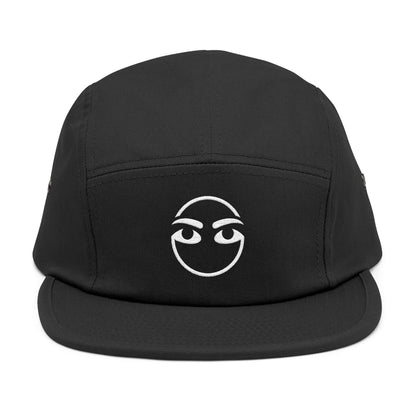 Black cap with a white face design on a white background. Expressive eyebrow and eye line-art graphic for embroidery. TEEZOCA