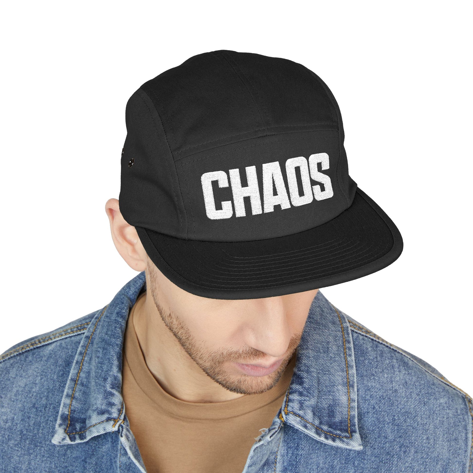 Black cap with 'CHAOS' text worn by a person on a white background. High-contrast CHAO⁠S wordmark design for embroidered caps. TEEZOCA