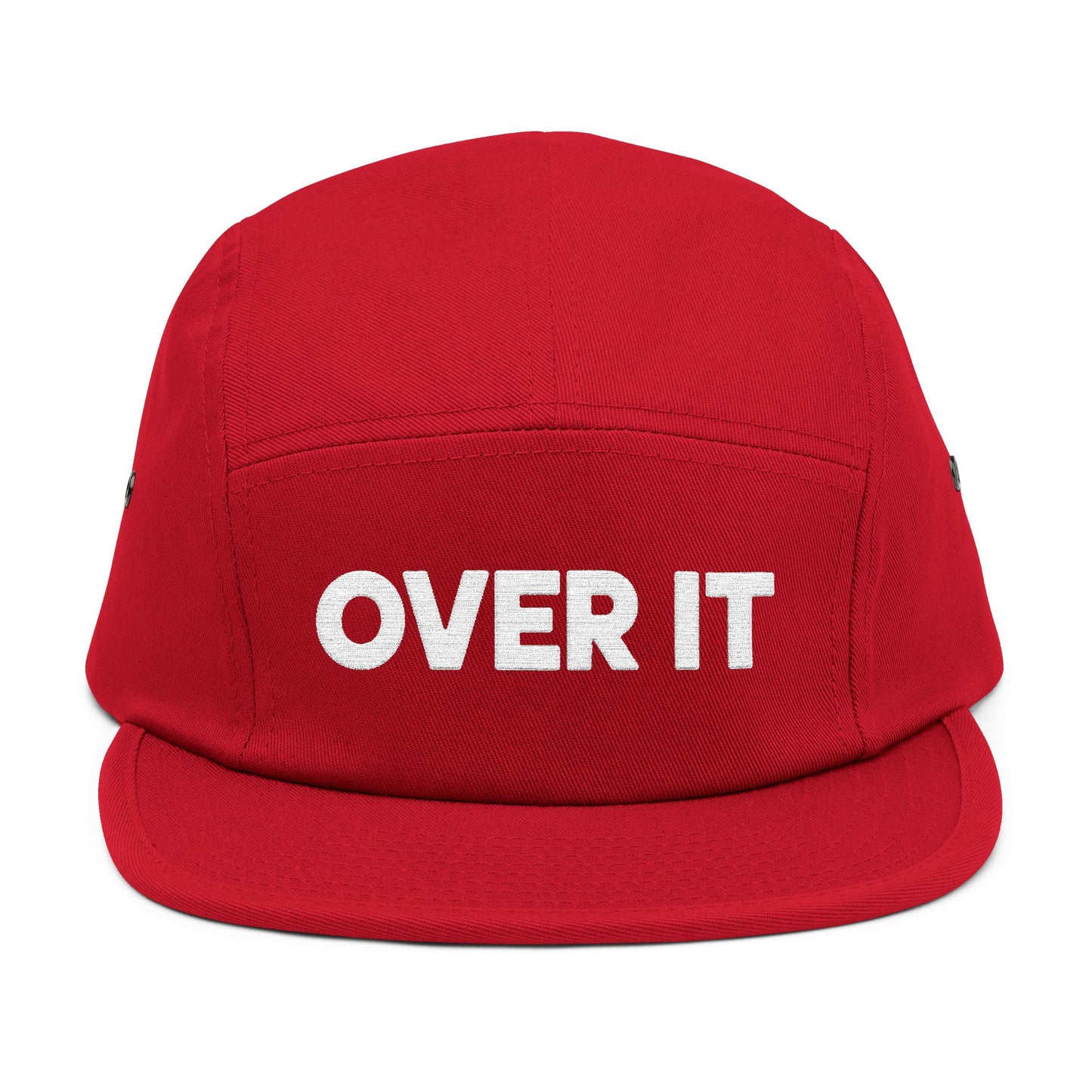 Red cap with 'OVER IT' text on a white background. OVER IT embroidered text design displayed on clean white typography. TEEZOCA