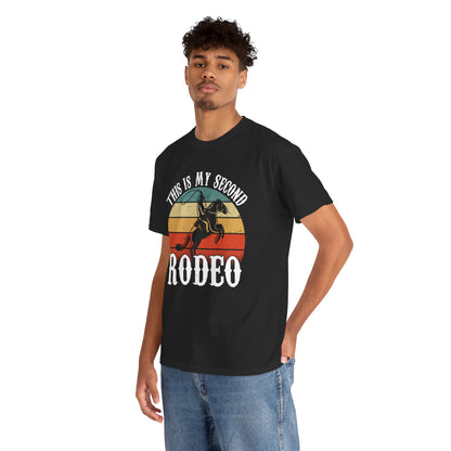 “Male model wearing Teezoca This Is My Second Rodeo shirt, retro cowboy sunset western humor t-shirt, black unisex front”


