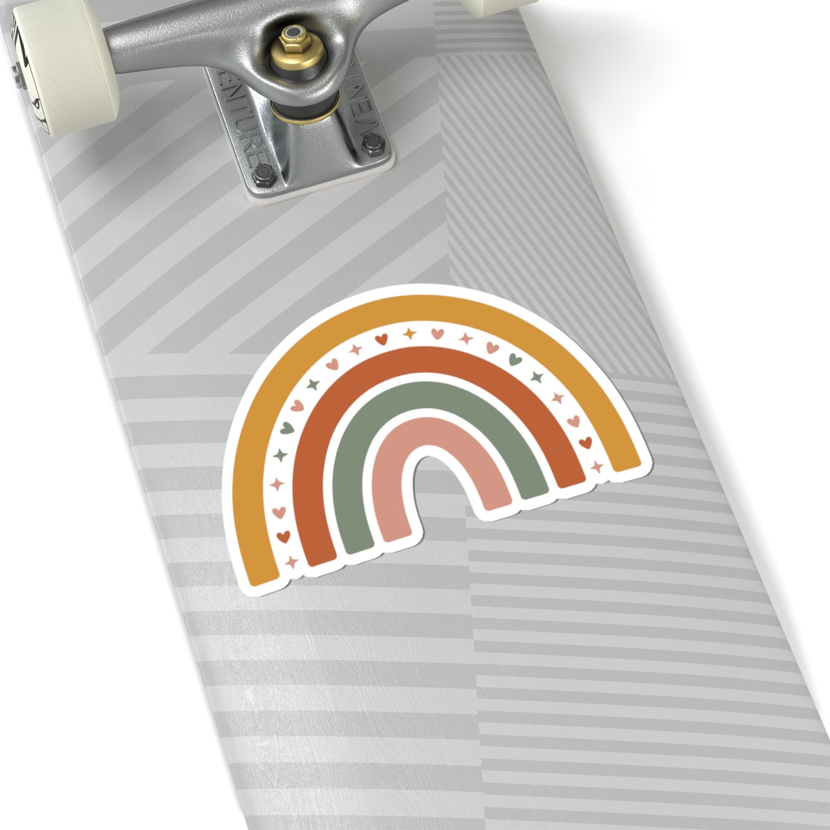 Skateboard with a rainbow-shaped sticker on a white background. TEEZOCA