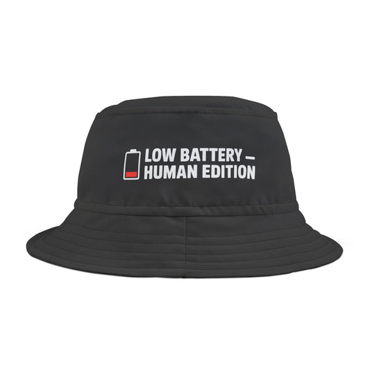 Black bucket hat with 'LOW BATTERY HUMAN EDITION' funny text on a white background. TEEZOCA