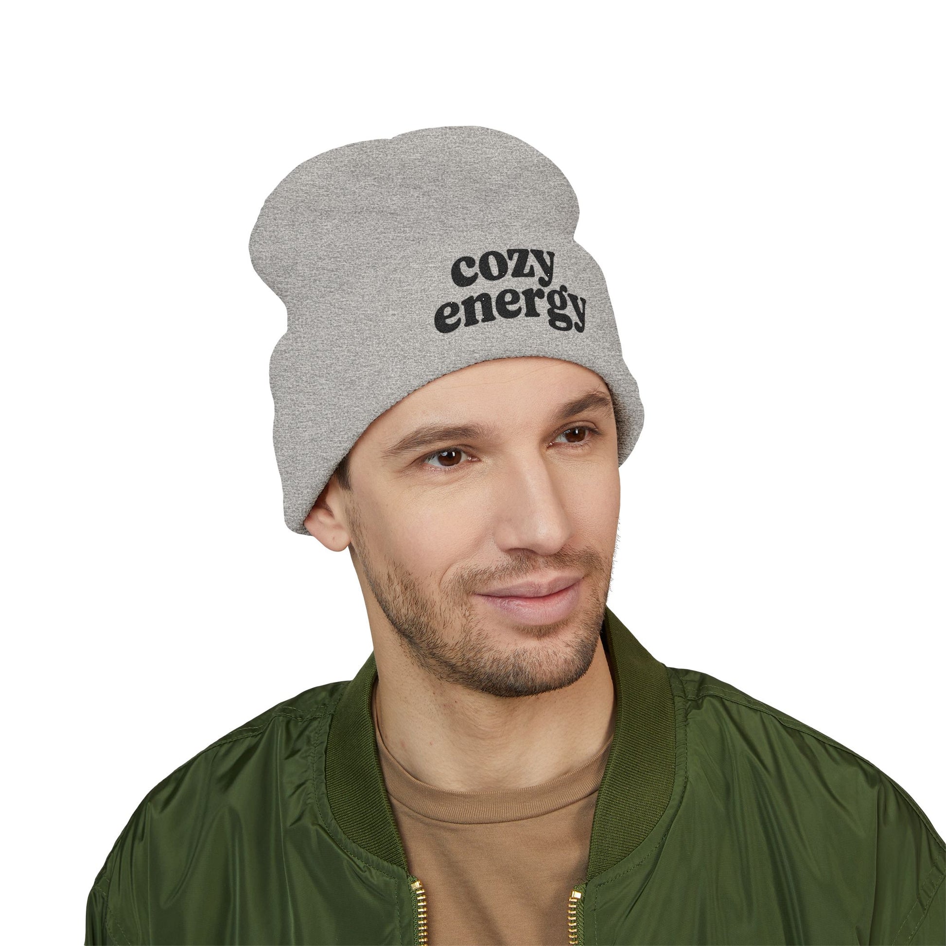 Man wearing a gray beanie with 'cozy energy' text on a white background