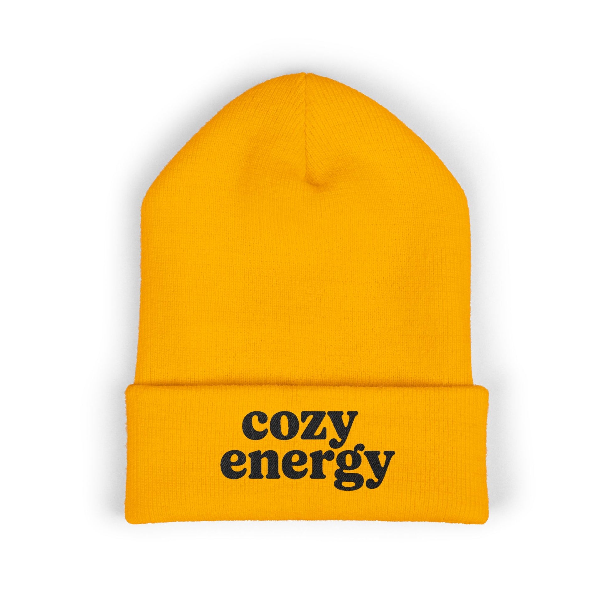Yellow beanie with 'cozy energy' text on a white background