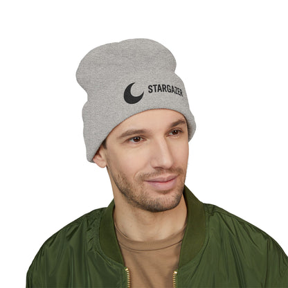 Man wearing a gray beanie with 'Stargazer' text and logo on a white background