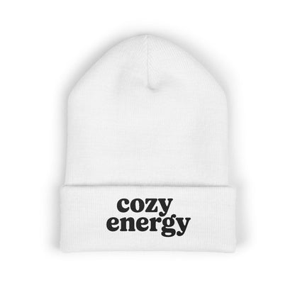 White beanie with 'cozy energy' text on a white background