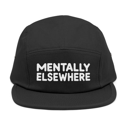 Black cap with 'MENTALLY ELSEWHERE' text on a white background. Mentally Elsewhere embroidered text design on five-panel cap. TEEZOCA