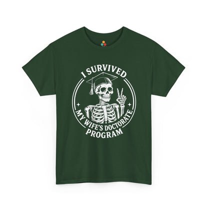 Green TEEZOCA t‑shirt featuring the “I Survived My Wife’s Doctorate Program” skeleton design.