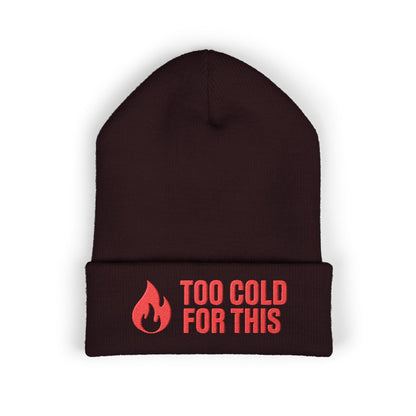 Cozy winter hat with humorous cold-weather message and flame graphic. Too Cold For This.