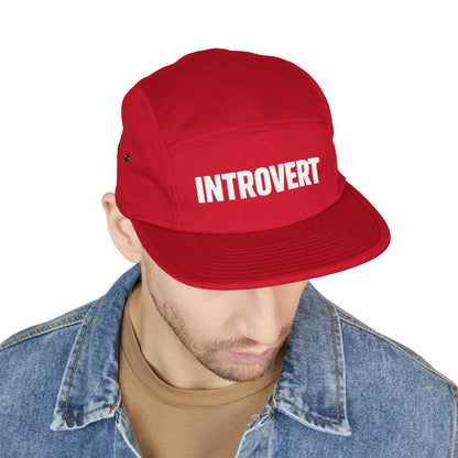 Red cap with 'INTROVERT' text worn by a person on a white background. Close-up of the “INTROVERT” embroidery designed for 5-panel caps. TEEZOCA