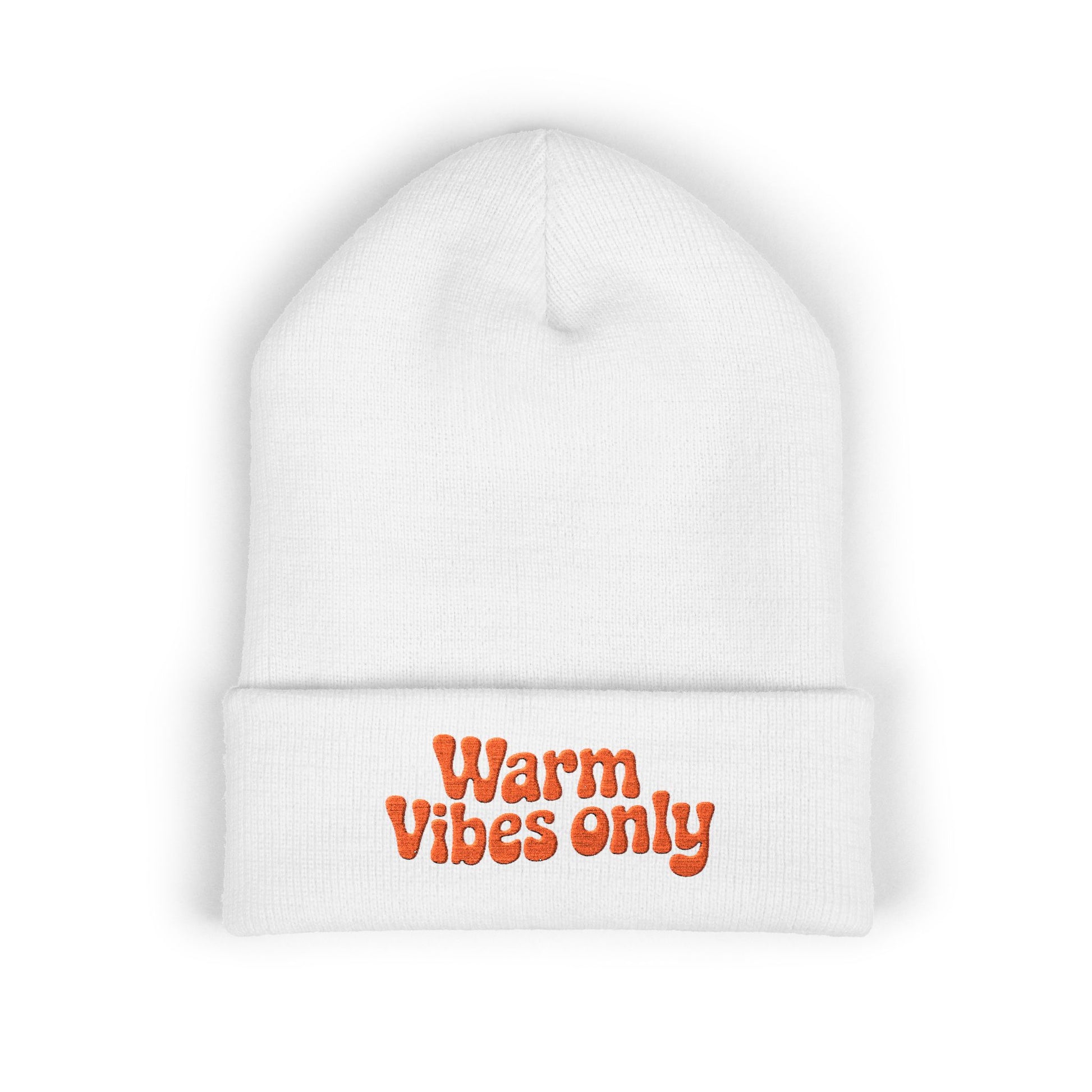 White beanie with 'Warm Vibes only' text in orange on a white background. Close-up of cheerful orange “Warm vibes only” embroidery on winter knit hat.