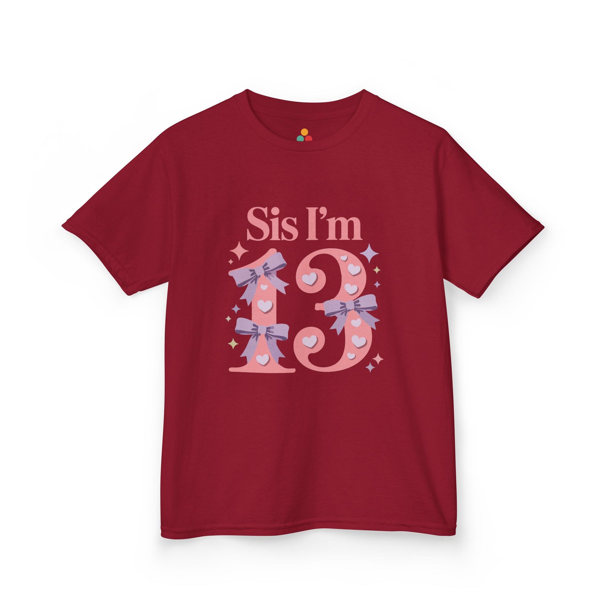 Red t‑shirt with pink “Sis I’m 13” design featuring hearts, lilac bows, and sparkles, flat front view.