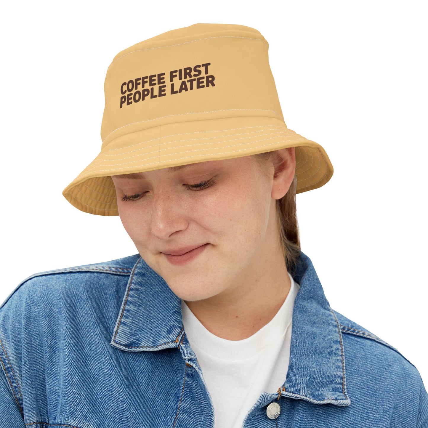 Funny yellow bucket hat with 'Coffee First, People Later' text on a white background. TEECOZA