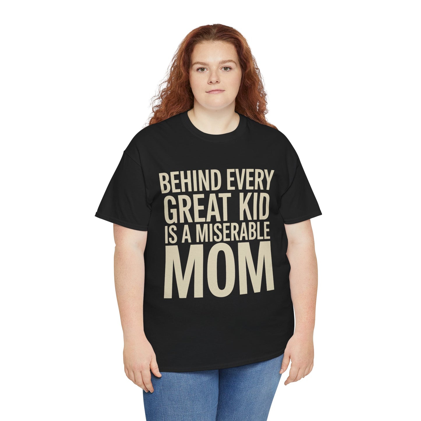 Woman wearing a black TEEZOCA “Behind Every Great Kid Is A Miserable Mom” sarcastic mom tee with jeans.