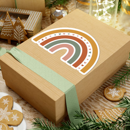 Wooden gift box with a rainbow design and green ribbon, surrounded by Christmas decorations. TEEZOCA